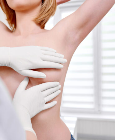 Cropped shot of a woman standing topless getting her breast examined during medical appointment at the hospital copyspace cancer awareness prevention examination checkup medicine health.